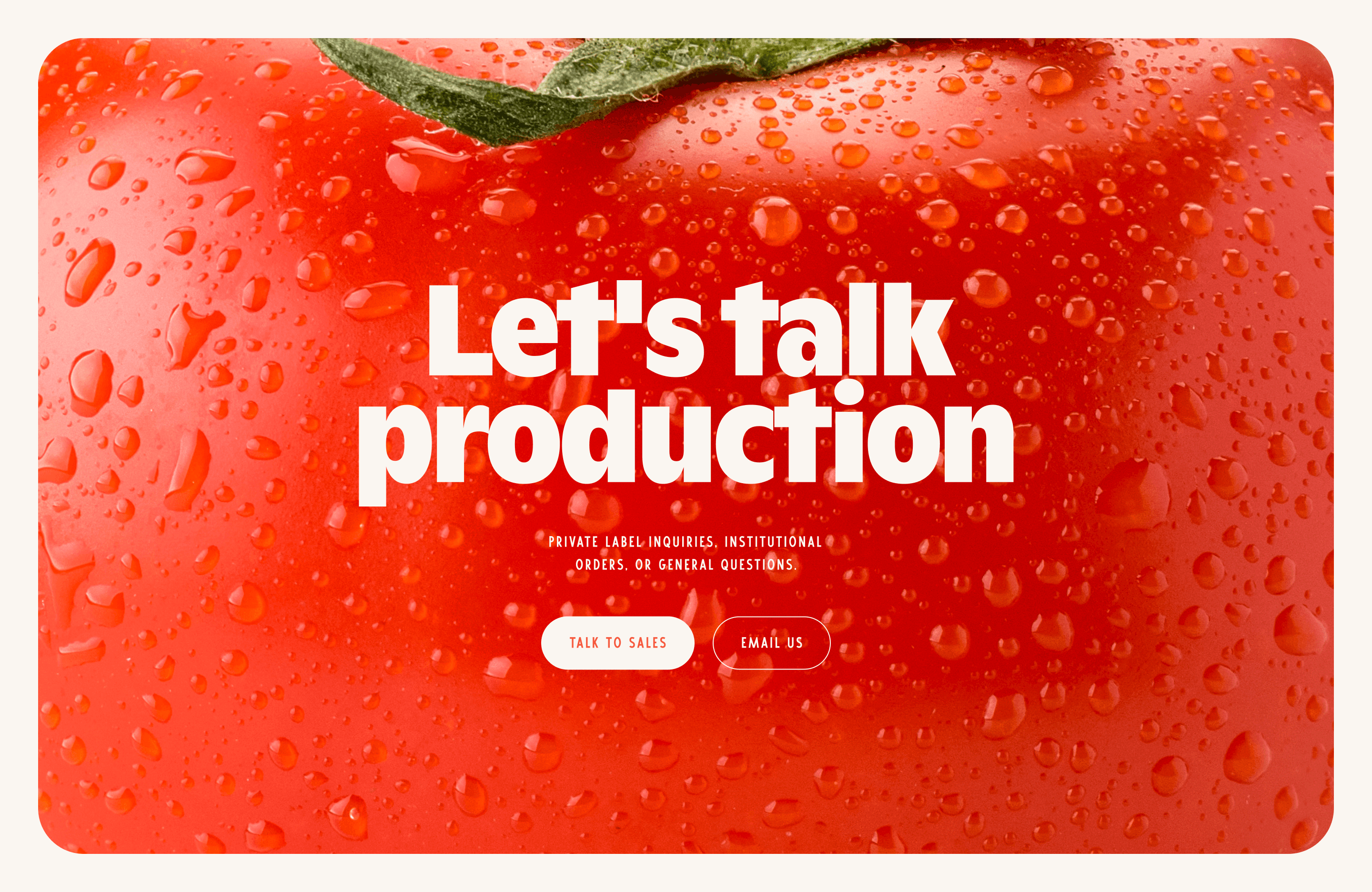 _ Close-up of a dewy red tomato with bold white text _Let's talk production_ and two buttons_ _Talk to Sales_ and _Email Us._