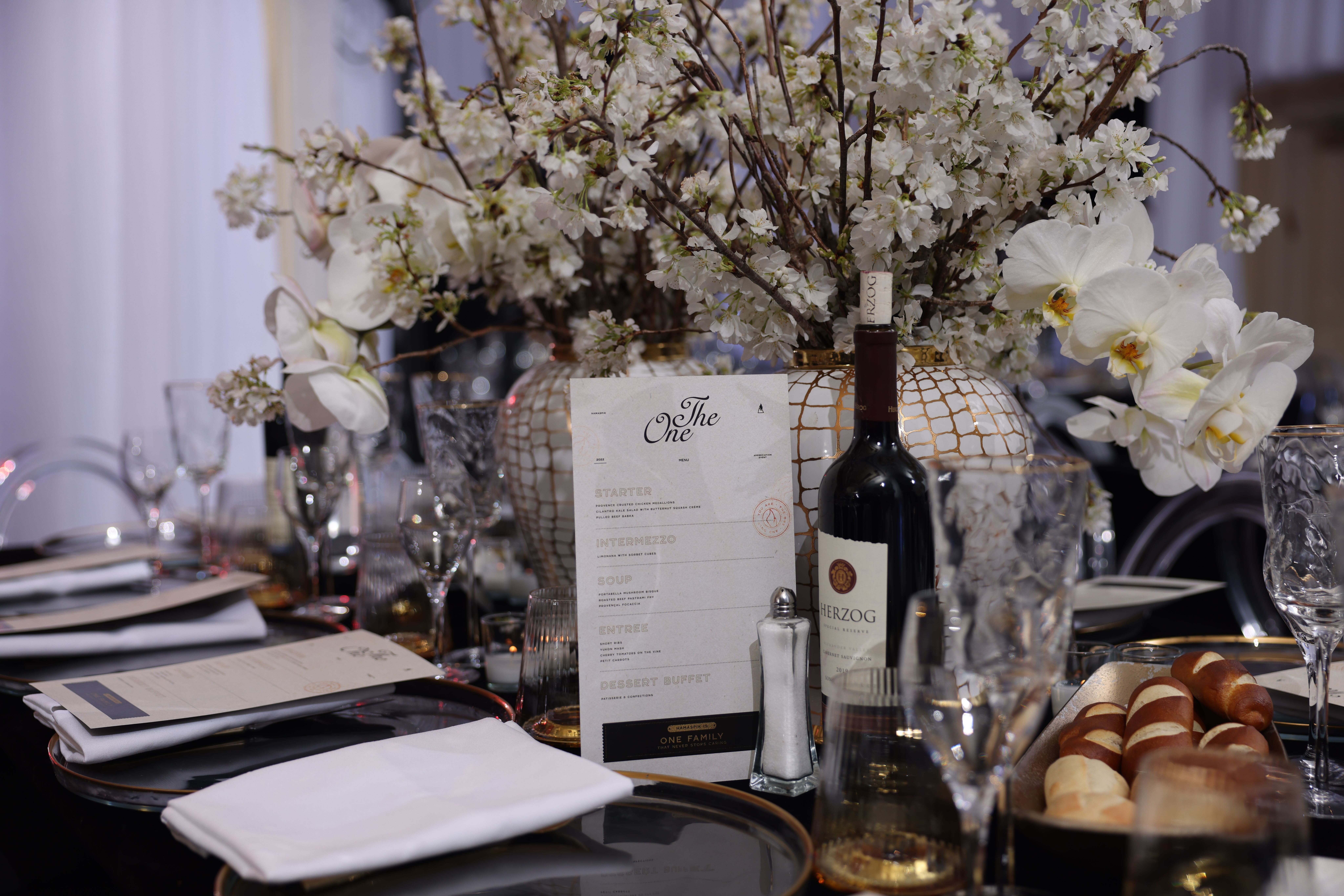 Herzog wine bottle, with a menu of the day in Ateres Avrohom for The One Event by Hamaspik